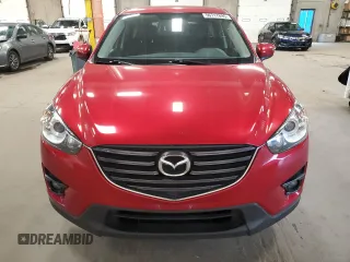2016 Mazda CX-5 Touring z VIN JM3KE4CY7G0898598, wystawiony jako Copart lot #56717895 z przebiegiem 103 548 mil mil oraz Szkoda całkowita • Salvage title. Historia ofert i sprzedaży dostępna na DreamBid. Obrazek 5.