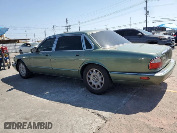 1999 Jaguar XJ with VIN SAJHX604XXC854217, listed as a Copart auction lot 56042735 with 127,092 mi miles and Salvage title. Bid and sale history available at DreamBid. Image 2.