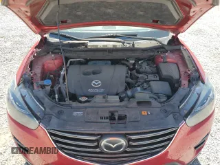 2016 Mazda CX-5 Grand Touring z VIN JM3KE2DYXG0840777, wystawiony jako Copart lot #49700585 z przebiegiem 116 469 mil mil oraz Szkoda całkowita • Salvage title. Historia ofert i sprzedaży dostępna na DreamBid. Obrazek 12.