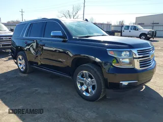 2015 Chevrolet Tahoe LTZ z VIN 1GNSKCKC3FR737927, wystawiony jako IAAI lot #41753778 z przebiegiem 136 757 mil mil oraz . Historia ofert i sprzedaży dostępna na DreamBid. Obrazek 1.
