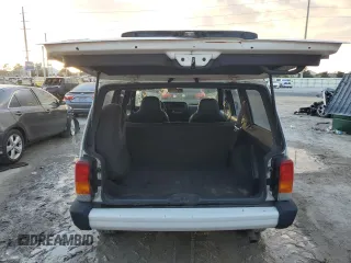1999 Jeep Cherokee Sport with VIN 1J4FT68S6XL578679, listed as a Copart auction lot 76697394 with 196,110 mi miles and Salvage title. Bid and sale history available at DreamBid. Image 6.
