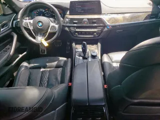 2018 BMW 5 Series M550i xDrive with VIN WBAJB9C54JB286450, listed as a Copart auction lot 61232125 with 88,479 mi miles and Salvage title. Bid and sale history available at DreamBid. Image 8.