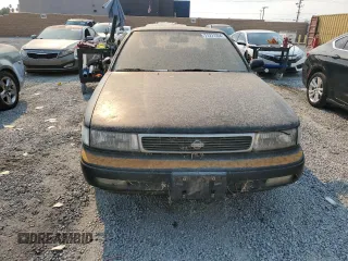 1992 Nissan Maxima z VIN JN1HJ01F1NT007180, wystawiony jako Copart lot #71271334 z przebiegiem 252 299 mil mil oraz Tytuł czysty. Historia ofert i sprzedaży dostępna na DreamBid. Obrazek 5.