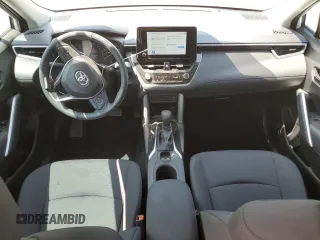 2024 Toyota Corolla Cross LE with VIN 7MUCAAAG7RV090677, listed as a Copart auction lot 57615565 with 6,910 mi miles and Salvage title. Bid and sale history available at DreamBid. Image 8.