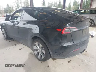 2023 Tesla Model Y Long Range with VIN 7SAYGDEE0PF909610, listed as a IAAI auction lot 41906081 with 20,656 mi miles and . Bid and sale history available at DreamBid. Image 3.