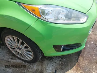 2014 Ford Fiesta Titanium z VIN 3FADP4FJ7EM203322, wystawiony jako IAAI lot #42448840 z przebiegiem 91 901 mil mil oraz . Historia ofert i sprzedaży dostępna na DreamBid. Obrazek 6.