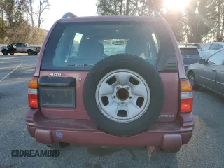 1999 Suzuki Vitara JX z VIN 2S3TD52V6X6101702, wystawiony jako Copart lot #42596125 z przebiegiem 225 614 mil mil oraz Tytuł czysty. Historia ofert i sprzedaży dostępna na DreamBid. Obrazek 6.