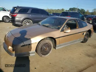 1987 Pontiac Fiero GT z VIN 1G2PG119XHP200243, wystawiony jako Copart lot #74389864 z przebiegiem 109 478 mil mil oraz Tytuł czysty. Historia ofert i sprzedaży dostępna na DreamBid. Obrazek 1.