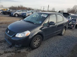 2012 Suzuki SX4 LE with VIN JS2YC5A32C6302316, listed as a Copart auction lot 81703544 with 87,411 mi miles and Salvage Title. Bid and sale history available at carsss.com. Image 1.