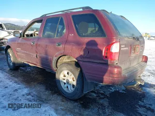 2002 Isuzu Rodeo z VIN 4S2DM58W124319936, wystawiony jako IAAI lot #41555285 z przebiegiem 143 035 mil mil oraz . Historia ofert i sprzedaży dostępna na DreamBid. Obrazek 3.