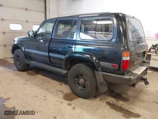 1997 Toyota Land Cruiser with VIN JT3HJ85J1V0184599, listed as a IAAI auction lot 41571386 with 305,201 mi miles. Bid and sale history available at carsss.com. Image 3.