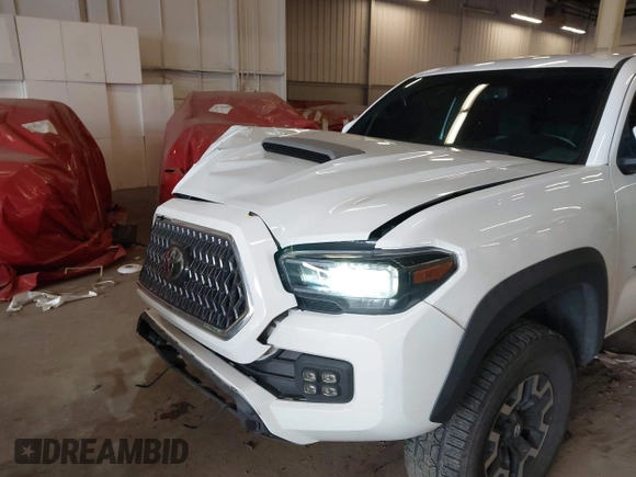 2021 Toyota Tacoma SR z VIN 5TFCZ5AN1MX268370, wystawiony jako IAAI lot #41922632 z przebiegiem 50 358 mil mil oraz . Historia ofert i sprzedaży dostępna na DreamBid. Obrazek 6.
