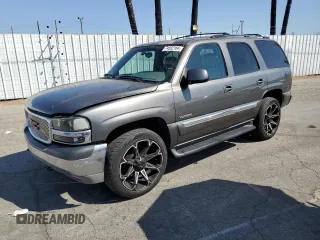 2001 GMC Yukon SLT z VIN 1GKEC13T21J141659, wystawiony jako Copart lot #74592164 z przebiegiem 106 867 mil mil oraz Szkoda całkowita • Salvage title. Historia ofert i sprzedaży dostępna na DreamBid. Obrazek 1.