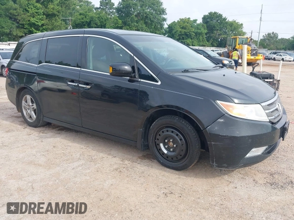 2011 Honda Odyssey Touring with VIN 5FNRL5H90BB070472, listed as a IAAI auction lot 42367710 with 203,589 mi miles and . Bid and sale history available at DreamBid. Image 1.