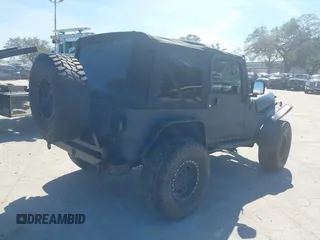 2003 Jeep Wrangler X with VIN 1J4FA39S03P314685, listed as a IAAI auction lot 41649741 with 119,924 mi miles. Bid and sale history available at carsss.com. Image 4.