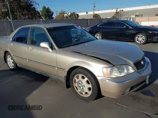 1999 Acura RL with VIN JH4KA9661XC005883, listed as a IAAI auction lot 40560595 with 165,195 mi miles. Bid and sale history available at carsss.com. Image 1.