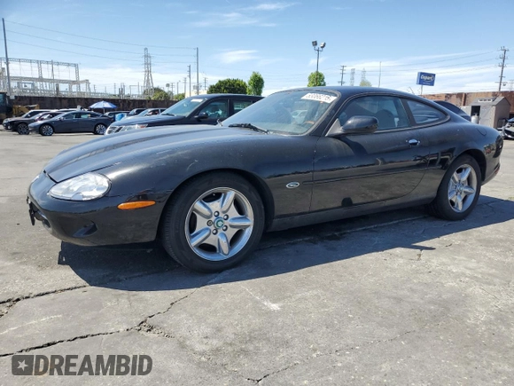 1997 Jaguar XK with VIN SAJGX5740VC014035, listed as a Copart auction lot 53066215 with 140,692 mi miles and Salvage Title. Bid and sale history available at DreamBid. Image 1.