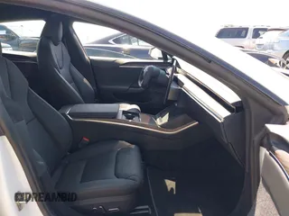 2023 Tesla Model S with VIN 5YJSA1E51PF499919, listed as a IAAI auction lot 42459166 with 6,612 mi miles and . Bid and sale history available at DreamBid. Image 5.