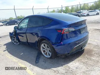 2023 Tesla Model Y Long Range with VIN 7SAYGDEE7PF702051, listed as a IAAI auction lot 42074182 with 50,473 mi miles and . Bid and sale history available at DreamBid. Image 3.