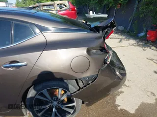 2016 Nissan Maxima Platinum z VIN 1N4AA6AP3GC385276, wystawiony jako IAAI lot #42547410 z przebiegiem 100 307 mil mil oraz . Historia ofert i sprzedaży dostępna na DreamBid. Obrazek 17.