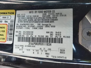 2014 Ford Fusion Titanium Hybrid with VIN 3FA6P0RU9ER111834, listed as a IAAI auction lot 41570337 with 121,099 mi miles. Bid and sale history available at carsss.com. Image 9.