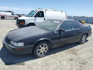 2002 Cadillac Eldorado Touring ETC z VIN 1G6ET12902B105467, wystawiony jako Copart lot #57694675 z przebiegiem Nie podano mil oraz Szkody całkowita. Historia ofert i sprzedaży dostępna na DreamBid. Obrazek 1.