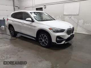 2021 BMW X1 xDrive28i with VIN WBXJG9C03M5T23289, listed as a IAAI auction lot 41603974 with 60,798 mi miles. Bid and sale history available at carsss.com. Image 1.