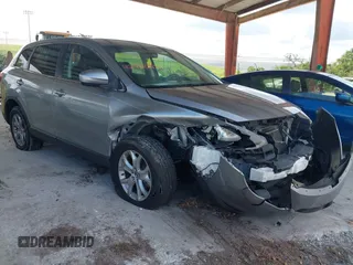 2015 Mazda CX-9 Sport z VIN JM3TB2BA0F0447436, wystawiony jako IAAI lot #42480482 z przebiegiem 127 557 mil mil oraz . Historia ofert i sprzedaży dostępna na DreamBid. Obrazek 1.