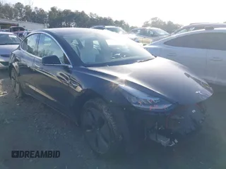 2019 Tesla Model 3 Mid Range z VIN 5YJ3E1EA4KF317872, wystawiony jako IAAI lot #41491269 z przebiegiem 90 772 mil mil oraz . Historia ofert i sprzedaży dostępna na DreamBid. Obrazek 1.
