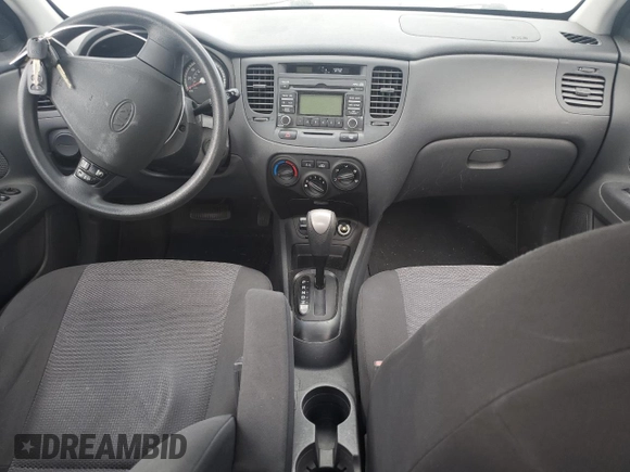 2009 Kia Rio LX with VIN KNADE223496469797, listed as a Copart auction lot 71005774 with 130,675 mi miles and Salvage Title. Bid and sale history available at DreamBid. Image 8.