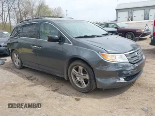 2012 Honda Odyssey Touring with VIN 5FNRL5H99CB028304, listed as a IAAI auction lot 42031916 with 216,185 mi miles and . Bid and sale history available at DreamBid. Image 1.