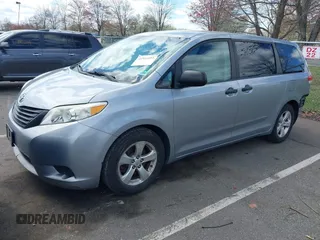 2013 Toyota Sienna L with VIN 5TDZK3DC9DS298333, listed as a IAAI auction lot 41941011 with 141,021 mi miles. Bid and sale history available at carsss.com. Image 2.
