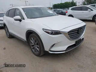 2023 Mazda CX-9 Grand Touring z VIN JM3TCBDY0P0634099, wystawiony jako IAAI lot #41943704 z przebiegiem 5 615 mil mil oraz . Historia ofert i sprzedaży dostępna na DreamBid. Obrazek 1.