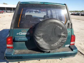 1996 Geo Tracker z VIN 2CNBE1363T6921541, wystawiony jako Copart lot #81647384 z przebiegiem 61 806 mil mil oraz Szkody całkowita. Historia ofert i sprzedaży dostępna na DreamBid. Obrazek 6.
