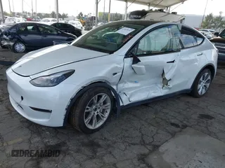2023 Tesla Model Y Long Range with VIN 7SAYGAEE7PF607195, listed as a IAAI auction lot 41819147 with 74,694 mi miles. Bid and sale history available at carsss.com. Image 2.