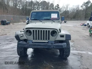 1999 Jeep Wrangler Sahara with VIN 1J4FY49S0XP480017, listed as a IAAI auction lot 41642577 with 154,068 mi miles. Bid and sale history available at carsss.com. Image 12.
