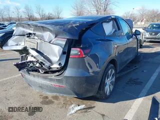 2020 Tesla Model Y Long Range with VIN 5YJYGDEE4LF030103, listed as a IAAI auction lot 41328929 with 64,896 mi miles and . Bid and sale history available at DreamBid. Image 4.