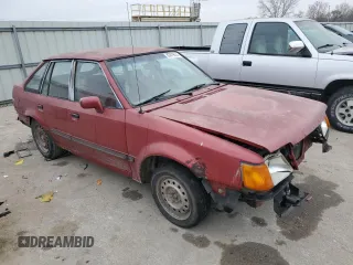 1989 Ford Escort z VIN 1FAPP959XKW361294, wystawiony jako Copart lot #83879674 z przebiegiem 12 406 mil mil oraz Szkody całkowita. Historia ofert i sprzedaży dostępna na DreamBid. Obrazek 4.