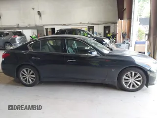 2015 Infiniti Q50 Premium z VIN JN1BV7AR9FM423471, wystawiony jako IAAI lot #42641857 z przebiegiem 86 919 mil mil oraz . Historia ofert i sprzedaży dostępna na DreamBid. Obrazek 13.