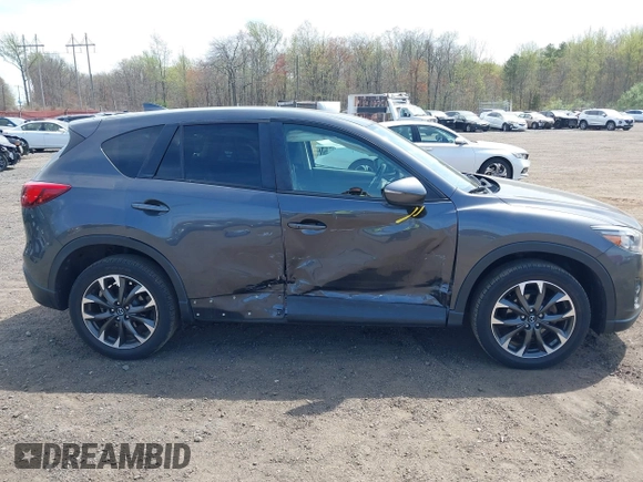 2016 Mazda CX-5 Grand Touring z VIN JM3KE4DY1G0893119, wystawiony jako IAAI lot #42049614 z przebiegiem 102 506 mil mil oraz . Historia ofert i sprzedaży dostępna na DreamBid. Obrazek 13.