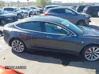 2018 Tesla Model 3 Long Range Battery with VIN 5YJ3E1EBXJF055203, listed as a IAAI auction lot 42019770 with 57,379 mi miles and . Bid and sale history available at DreamBid. Image 13.