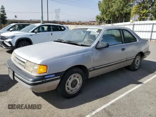 1989 Ford Tempo z VIN 1FAPP31X0KK113919, wystawiony jako Copart lot #76599314 z przebiegiem 65 823 mil mil oraz Tytuł czysty. Historia ofert i sprzedaży dostępna na DreamBid. Obrazek 1.