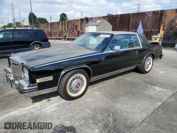 1985 Cadillac Eldorado z VIN 1G6EL578XFE640091, wystawiony jako Copart lot #71849374 z przebiegiem 30 631 mil mil oraz Szkody całkowita. Historia ofert i sprzedaży dostępna na DreamBid. Obrazek 1.