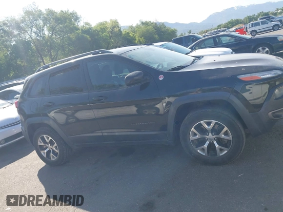 2015 Jeep Cherokee Trailhawk with VIN 1C4PJMBS4FW556822, listed as a IAAI auction lot 42412874 with 129,865 mi miles and . Bid and sale history available at DreamBid. Image 13.