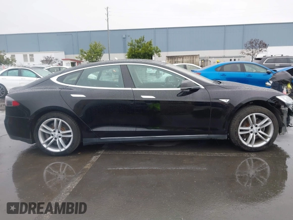 2013 Tesla Model S with VIN 5YJSA1CN0DFP20053, listed as a IAAI auction lot 41470660 with 61,568 mi miles and . Bid and sale history available at DreamBid. Image 14.