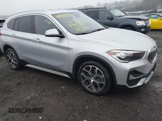 2021 BMW X1 xDrive28i with VIN WBXJG9C04M5T79810, listed as a IAAI auction lot 41471536 with 75,345 mi miles. Bid and sale history available at carsss.com. Image 1.