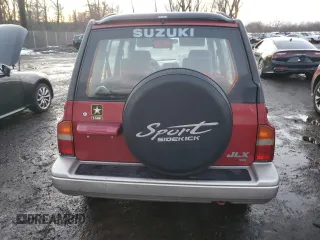 1996 Suzuki Sidekick z VIN JS3TD21V2T4103586, wystawiony jako Copart lot #83492154 z przebiegiem 98 298 mil mil oraz Szkody całkowita. Historia ofert i sprzedaży dostępna na DreamBid. Obrazek 6.
