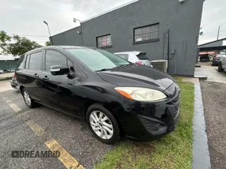 2015 Mazda 5 Sport z VIN JM1CW2BLXF0182880, wystawiony jako Copart lot #56959895 z przebiegiem 117 395 mil mil oraz Czysty tytuł • Clean title. Historia ofert i sprzedaży dostępna na DreamBid. Obrazek 1.