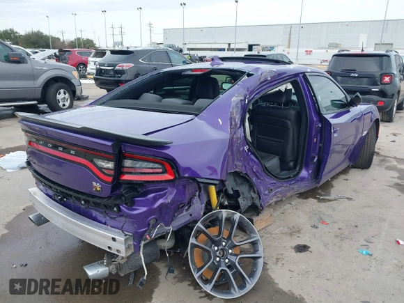 2023 Dodge Charger Scat Pack Widebody with VIN 2C3CDXGJ5PH699595, listed as a IAAI auction lot 41303894 with 1,828 mi miles and . Bid and sale history available at DreamBid. Image 4.