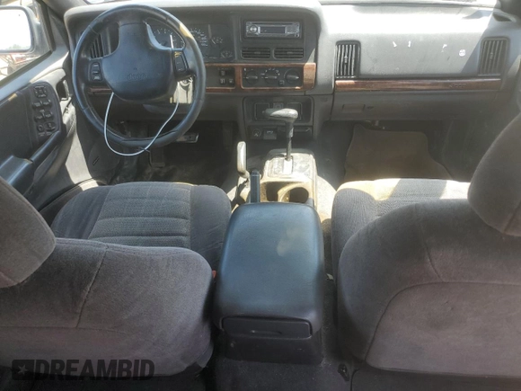 1997 Jeep Grand Cherokee Laredo z VIN 1J4GZ58S6VC636803, wystawiony jako Copart lot #59977115 z przebiegiem Nie podano mil oraz Szkoda całkowita • Salvage title. Historia ofert i sprzedaży dostępna na DreamBid. Obrazek 8.